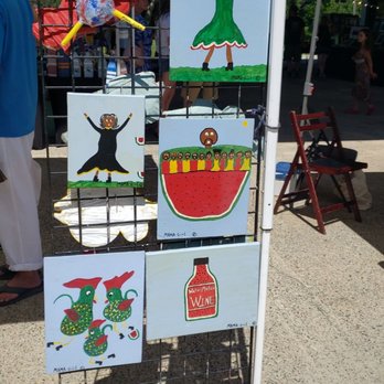 Pearl Market - a display of paintings on a rack - Farmers Market Near Me - Cape Charles, Virginia Pearl Market - a display of paintings on a rack - Farmers Market Near Me - Cape Charles, Virginia