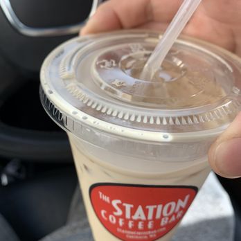 Station Coffee Bar & Bistro - a hand holding a cup of coffee - Coffee & Tea Near Me - Centralia, Washington