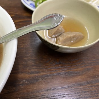 Pho 99 - a bowl of soup with a spoon in it - Vietnamese Near Me - Seattle, Washington Pho 99 - a bowl of soup with a spoon in it - Vietnamese Near Me - Seattle, Washington