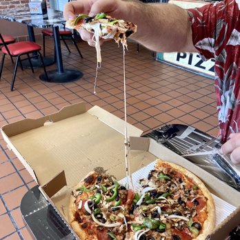 Ameci Pizza Kitchen - Glendale - Cheese pull on the Deluxe Pizza   14" - Pizza Near Me - Glendale, California