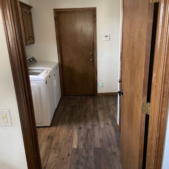 Royal Home Improvement - a hallway leading to a washer and dryer - Handyman Near Me Royal Home Improvement - a hallway leading to a washer and dryer - Handyman Near Me