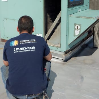 Interstate Air Conditioning & Heating - HVAC Technician Visually Looking at a roof top air conditioning unit. - Heating & Air Conditioning/HVAC Near Me - New York, New York Interstate Air Conditioning & Heating - HVAC Technician Visually Looking at a roof top air conditioning unit. - Heating & Air Conditioning/HVAC Near Me - New York, New York