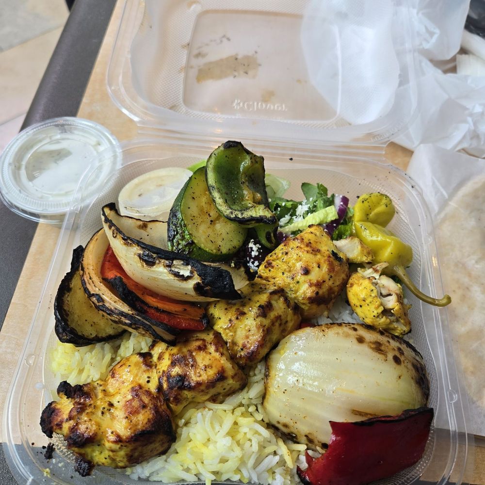 Chicken kabobs with half rice and half salad. Chicken kabobs with half rice and half salad.