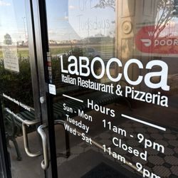 La Bocca Italian Restaurant & Pizzeria - Front entrance, with hours of operation