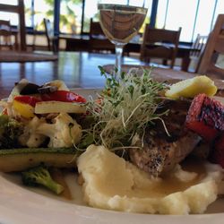 Efren's restaurant & bar - operated by Joris - Yellowtail on a bed of mashed potatoes, carrot puree, cream of leek with basil, stirfried veggies and a light buerre blanc sauce