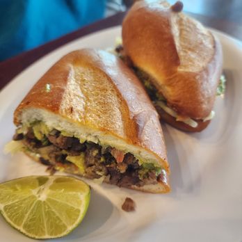 Tacologia - Asada torta with lettuce, guacamole, and tomatoes - Tacos Near Me - Moore, Oklahoma Tacologia - Asada torta with lettuce, guacamole, and tomatoes - Tacos Near Me - Moore, Oklahoma