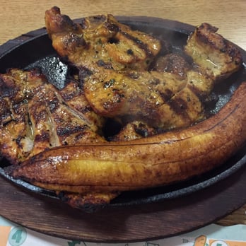 Pollos A La Brasa Mario - Grilled Pork on a skillet! - Colombian Near Me - Jackson Heights, New York Pollos A La Brasa Mario - Grilled Pork on a skillet! - Colombian Near Me - Jackson Heights, New York