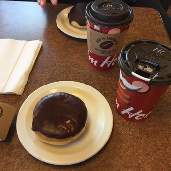 Tim Hortons - a donut and two cups of coffee - New American Near Me - Toledo, Ohio Tim Hortons - a donut and two cups of coffee - New American Near Me - Toledo, Ohio