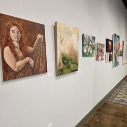 Art On 1st - Many other artworks hanging from one of the walls.