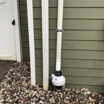 Radon Shield - Radon fan in back exterior - Environmental Testing Near Me