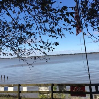 The Wet Deck - Vew of the lake from under the ancient pecan tree on the deck. - American Near Me - Livingston, Texas The Wet Deck - Vew of the lake from under the ancient pecan tree on the deck. - American Near Me - Livingston, Texas