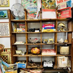 Urban Redeux - Cobblers rack filled with vintage toys and games.