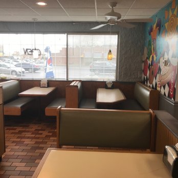 Jester's Fast Food - Interior of a fast food restaurant with booth seating, a mural on the wall, and large windows showing parked cars outside. - Fast Food Near Me - Elgin, Illinois