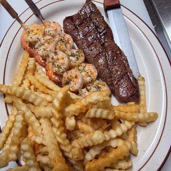 P-Nut Gallery Backroads - A hand-cut 8 oz sirloin, grilled to order and paired with tender seasoned shrimp, served alongside a generous helping of crispy golden fries - Seafood Near Me - Taylor, Wisconsin
