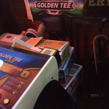 The Hideaway Bar - Golden Tee video game with...3 boxes of Cheetos stacked between the console and the screen, and a vacuum cleaner tucked in next to it. - Dive Bars Near Me - Orlando, Florida