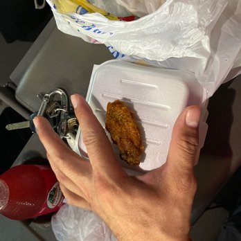 Gao's Hot Wings - a hand holding a plastic container of food - Chicken Wings Near Me - Marietta, Georgia