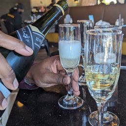 a person pouring a glass of wine a person pouring a glass of wine