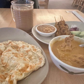 Kapitan - Roti canai n curry chicken dipping (bottom), satay chicken (top right), Teh Tarik (drink) - Asian Fusion Near Me - Chicago, Illinois Kapitan - Roti canai n curry chicken dipping (bottom), satay chicken (top right), Teh Tarik (drink) - Asian Fusion Near Me - Chicago, Illinois