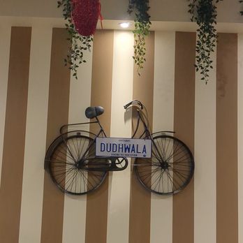 Shake Square - a bicycle hanging on a wall - Indian Near Me - Brampton, Ontario Shake Square - a bicycle hanging on a wall - Indian Near Me - Brampton, Ontario