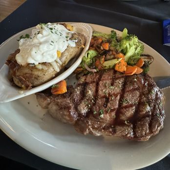 Osteria Kayla - 12oz Ribeye with loaded baked potato and roasted vegetables - Italian Near Me - Fremont, Nebraska Osteria Kayla - 12oz Ribeye with loaded baked potato and roasted vegetables - Italian Near Me - Fremont, Nebraska