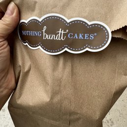 a person holding a brown paper bag a person holding a brown paper bag