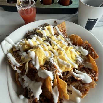 Broken Yolk Cafe - Barbacoa Chilaquiles with both red and green salsa. - Breakfast & Brunch Near Me - McKinney, Texas Broken Yolk Cafe - Barbacoa Chilaquiles with both red and green salsa. - Breakfast & Brunch Near Me - McKinney, Texas