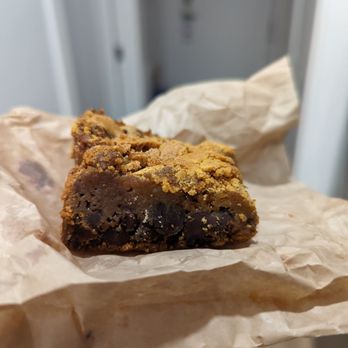Nordstrom Grill - a hand holding a piece of brownie - New American Near Me - Salt Lake City, Utah Nordstrom Grill - a hand holding a piece of brownie - New American Near Me - Salt Lake City, Utah