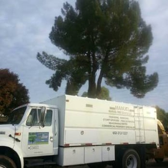 Manuel Tree Service, LLC - a truck parked in a parking lot - Tree Services Near Me Manuel Tree Service, LLC - a truck parked in a parking lot - Tree Services Near Me