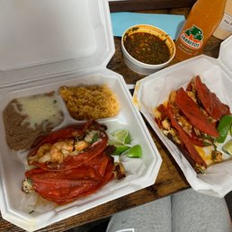 two takeout containers of food on a table two takeout containers of food on a table