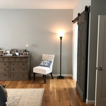 Dino's Contracting - a bedroom with a chair and a dresser - General Contractors Near Me Dino's Contracting - a bedroom with a chair and a dresser - General Contractors Near Me