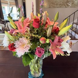 Peonies, lilies, red and pink roses, and more.