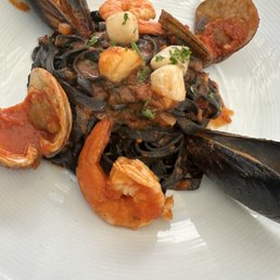 Tagliatelle Al Frutti de mare. Squid ink pasta with fresh shellfish.