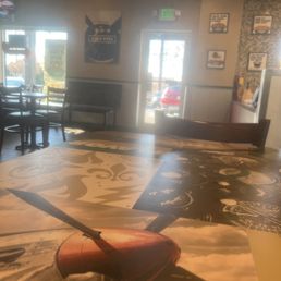 the inside of a restaurant with tables and chairs