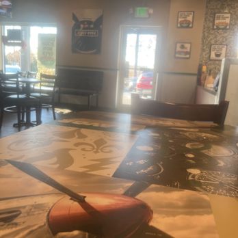 Wingstop - the inside of a restaurant with tables and chairs - Chicken Wings Near Me - Owings Mills, Maryland
