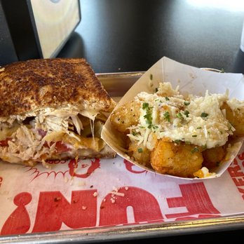 Tom & Chee - Half eaten Crispy Garlic Chicken and Garlic Cheese and Chive Tots. - American Near Me - Oklahoma City, Oklahoma Tom & Chee - Half eaten Crispy Garlic Chicken and Garlic Cheese and Chive Tots. - American Near Me - Oklahoma City, Oklahoma