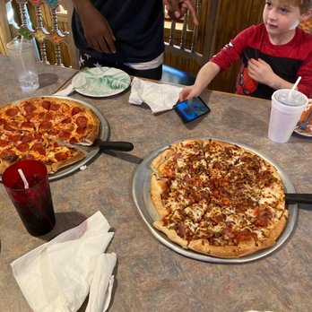 Bulldog Pizza Etc - two children sitting at a table with two pizzas - Pizza Near Me - Jefferson, Texas