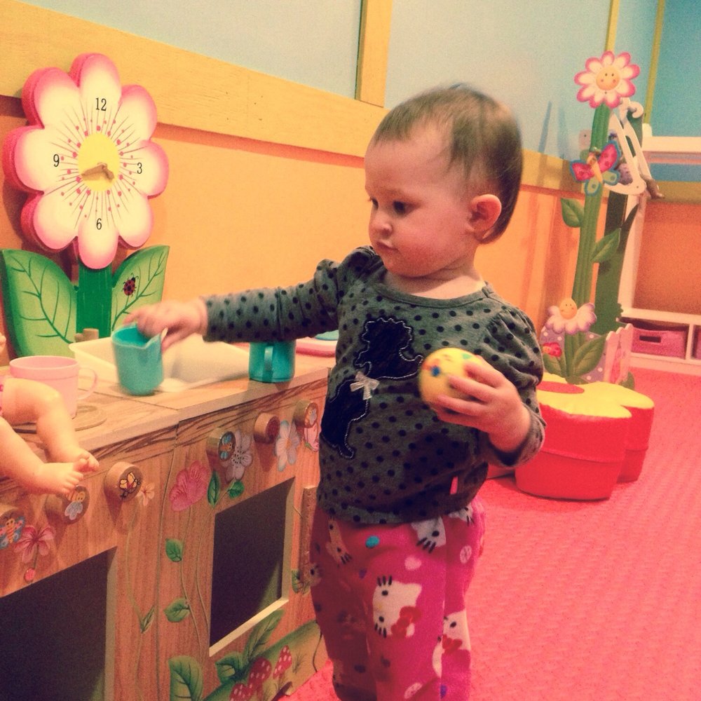 Toddling around in the "baby section". Filled with age appropriate toys and mirrors.