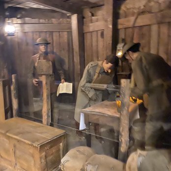 Cantigny - Museum - Mannequins dressed in historical military uniforms are arranged in a wooden display at Cantigny Park's military museum. - Museums Near Me - Wheaton, Illinois
