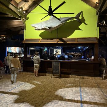 Square Grouper Tiki Bar - Great white over the bar instead of a grouper... - Tiki Bars Near Me - Fort Pierce, Florida