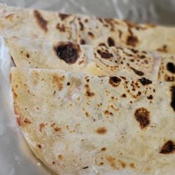 Baleada: Handmade flour tortilla filled with refried beans, cream, cheese - choose plain or steak &/or egg