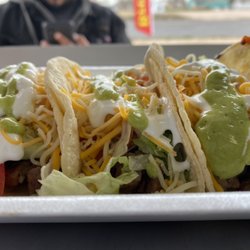 Girls On Fire Food Truck - Steak tacos topped with sour cream and avocado sauce.