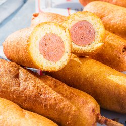 Aroma Concessions - Sink your teeth into our classic corn dogs--plump, juicy sausage dipped in golden, fluffy cornmeal batter and fried to crispy perfection.