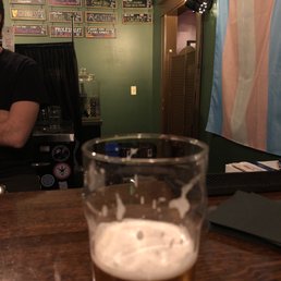 a glass of beer on a bar counter a glass of beer on a bar counter