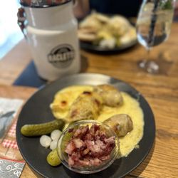 Raclette Factory - White wine and goat cheese raclette with potatoes and bacon.