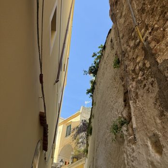 Amalfi - Looking up between buildings on a narrow street - Local Flavor Near Me