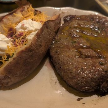 The Butterscotch Den - Ribeye Steak and compound butter with a loaded baked potato. - Steakhouses Near Me - Sacramento, California The Butterscotch Den - Ribeye Steak and compound butter with a loaded baked potato. - Steakhouses Near Me - Sacramento, California