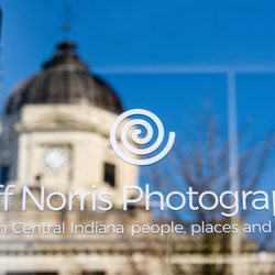 Jeff Norris Photography - Reflection of Bloomington's courthouse with my storefront window sign