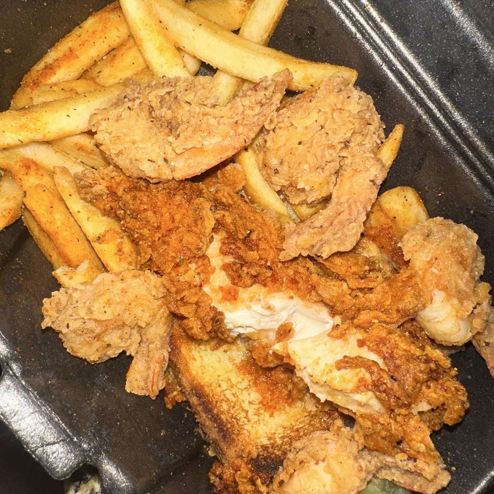 Nashville chicken tender with fried shrimp fries and garlic bread.