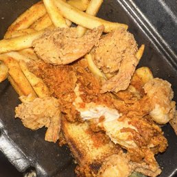 Nashville chicken tender with fried shrimp fries and garlic bread. Nashville chicken tender with fried shrimp fries and garlic bread.