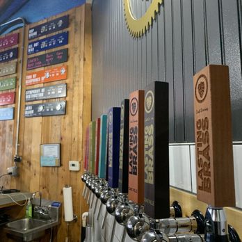 Lasting Brass - The paddles and flavor list on the wall. - Breweries Near Me - Oakville, Connecticut